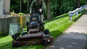 Employee mowing yard in neighborhood.